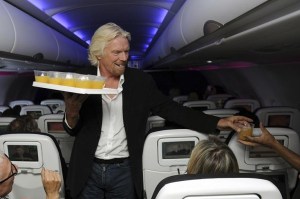 Richard Branson serving customers on a Virgin flight